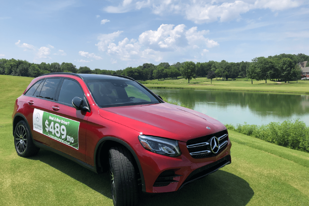 Red Mercedes Benz car on golf course